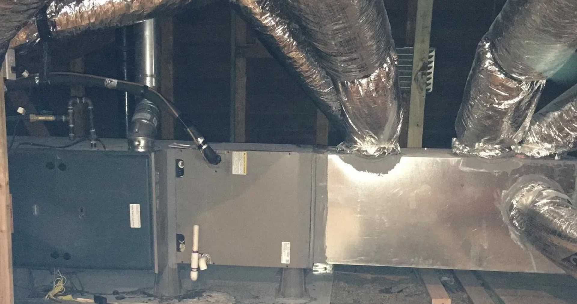 Air Fair Heat and Air LLC - A room with a lot of pipes coming out of the ceiling.