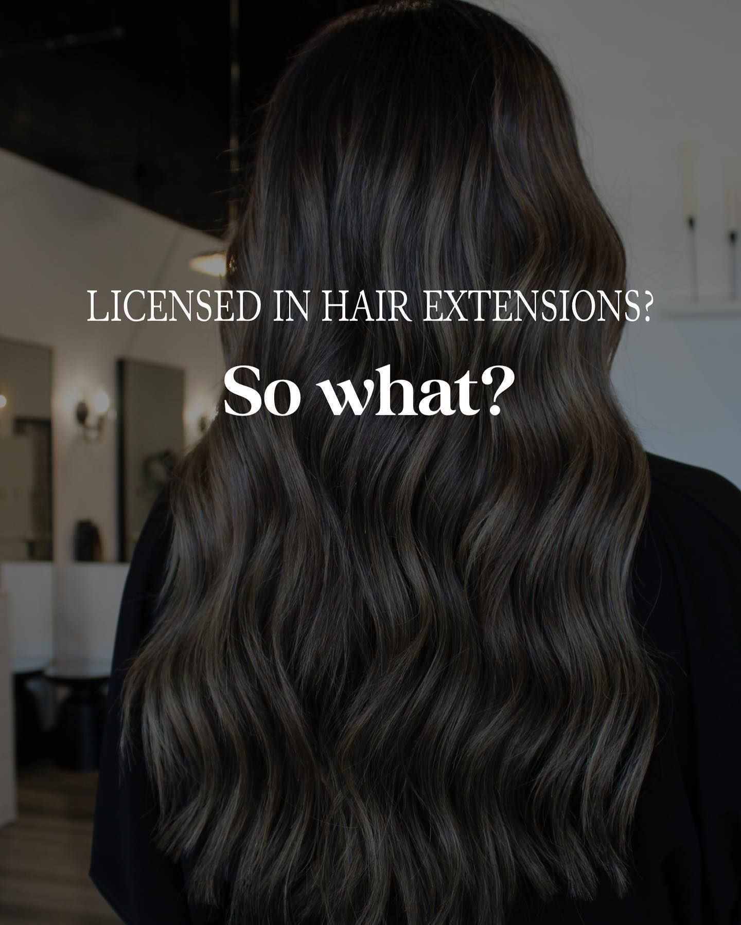 a woman with long dark hair is standing in front of a sign that says licensed in hair extensions so what ?