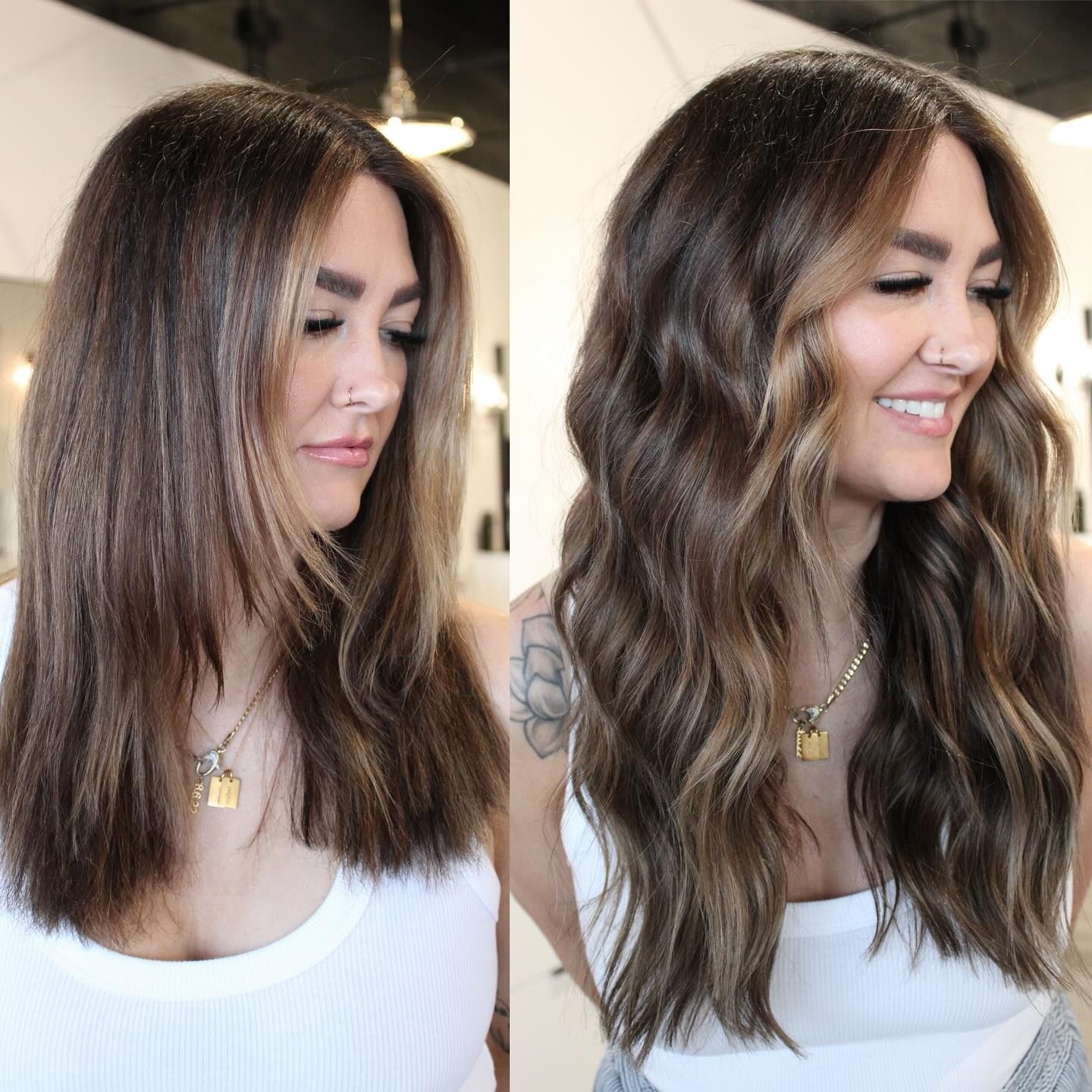 a woman with long brown hair is wearing a white tank top and smiling .