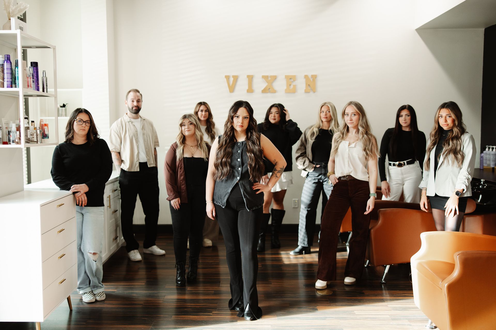two women are standing next to each other on a deck holding wine glasses .