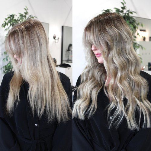 a woman with long blonde hair is wearing a black shirt .