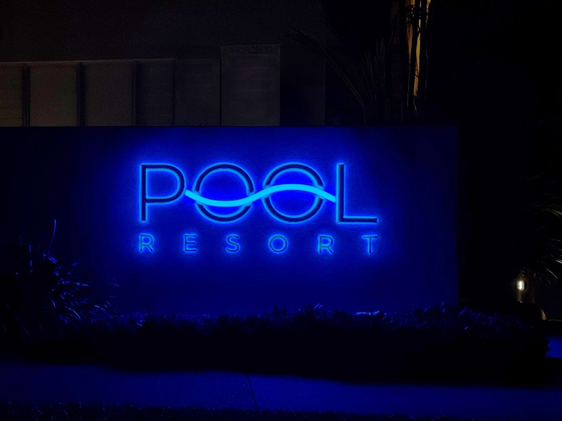 An illuminated blue neon sign reading
