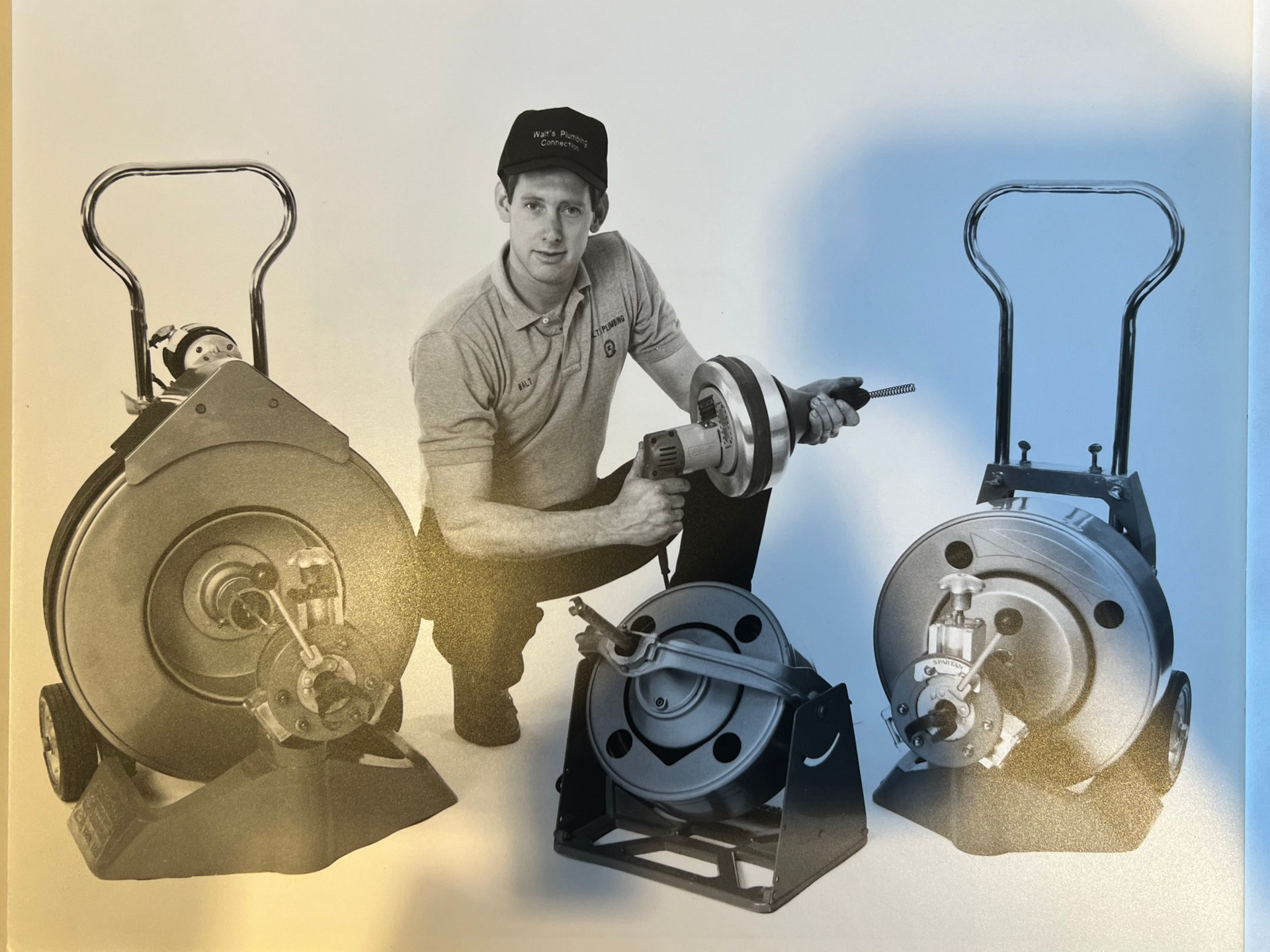 Walt demonstrating industrial equipment with three devices and stands.