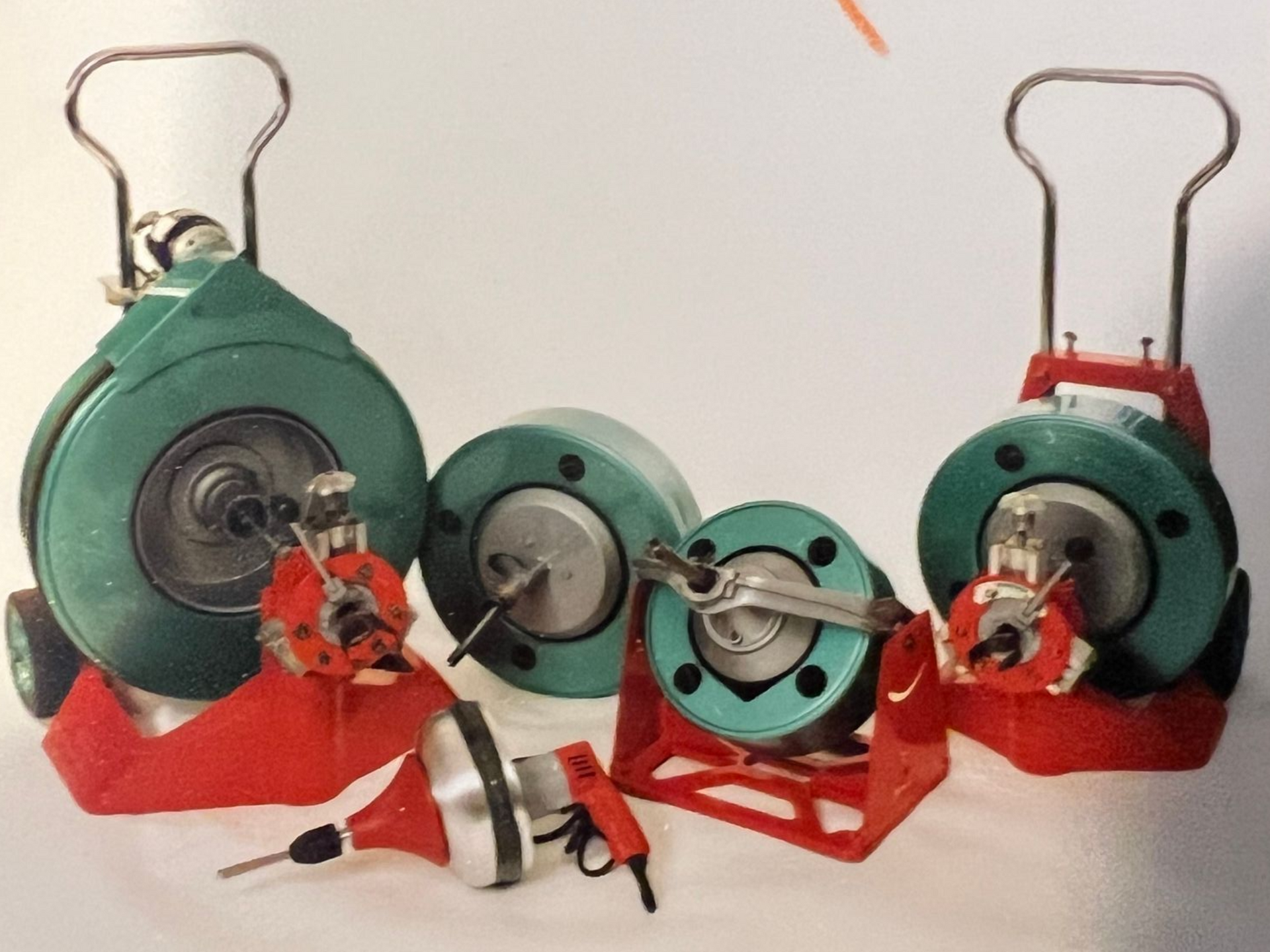 Several green and red drain cleaning machines.