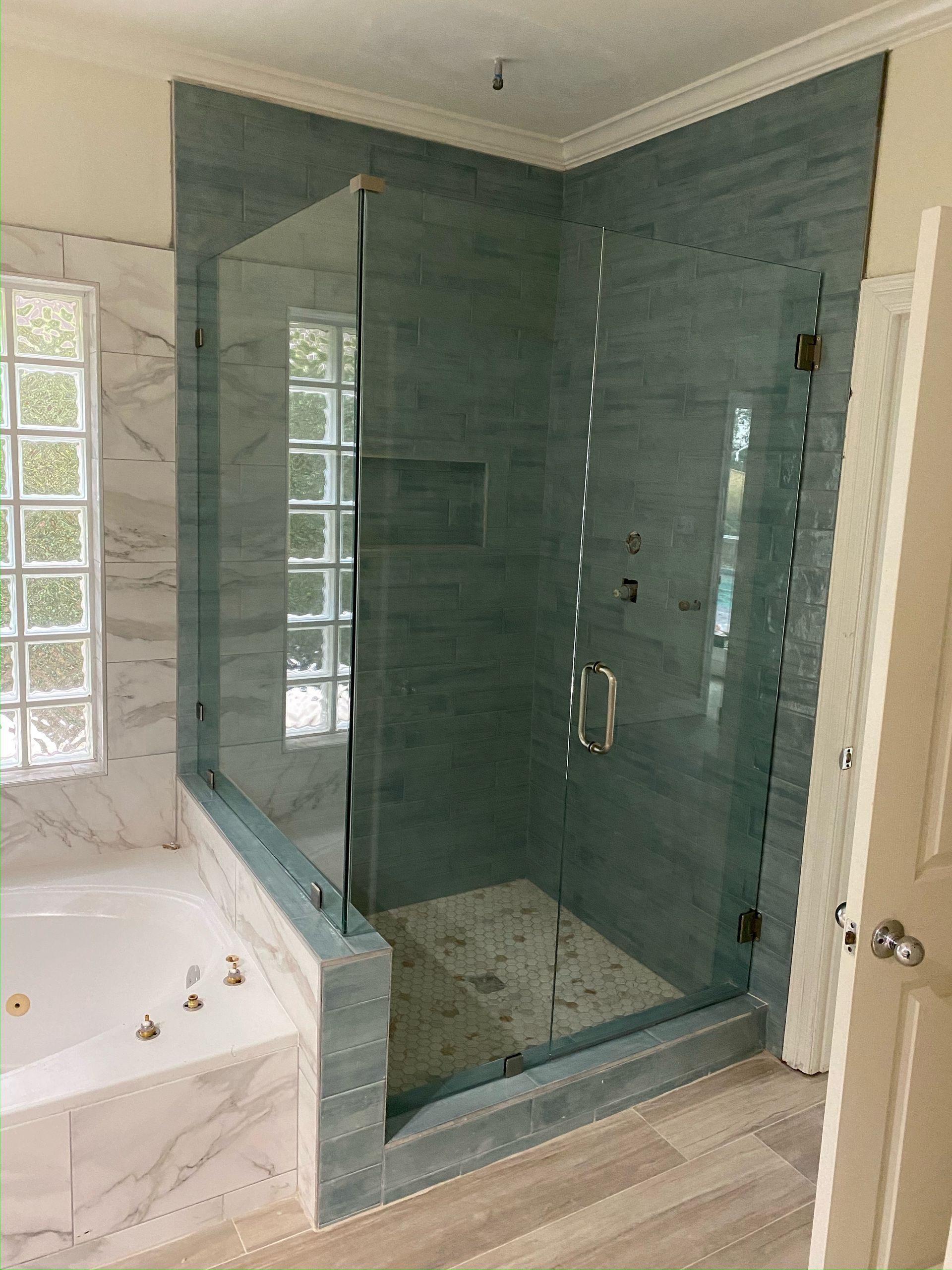 A bathroom with a walk in shower and a bathtub.