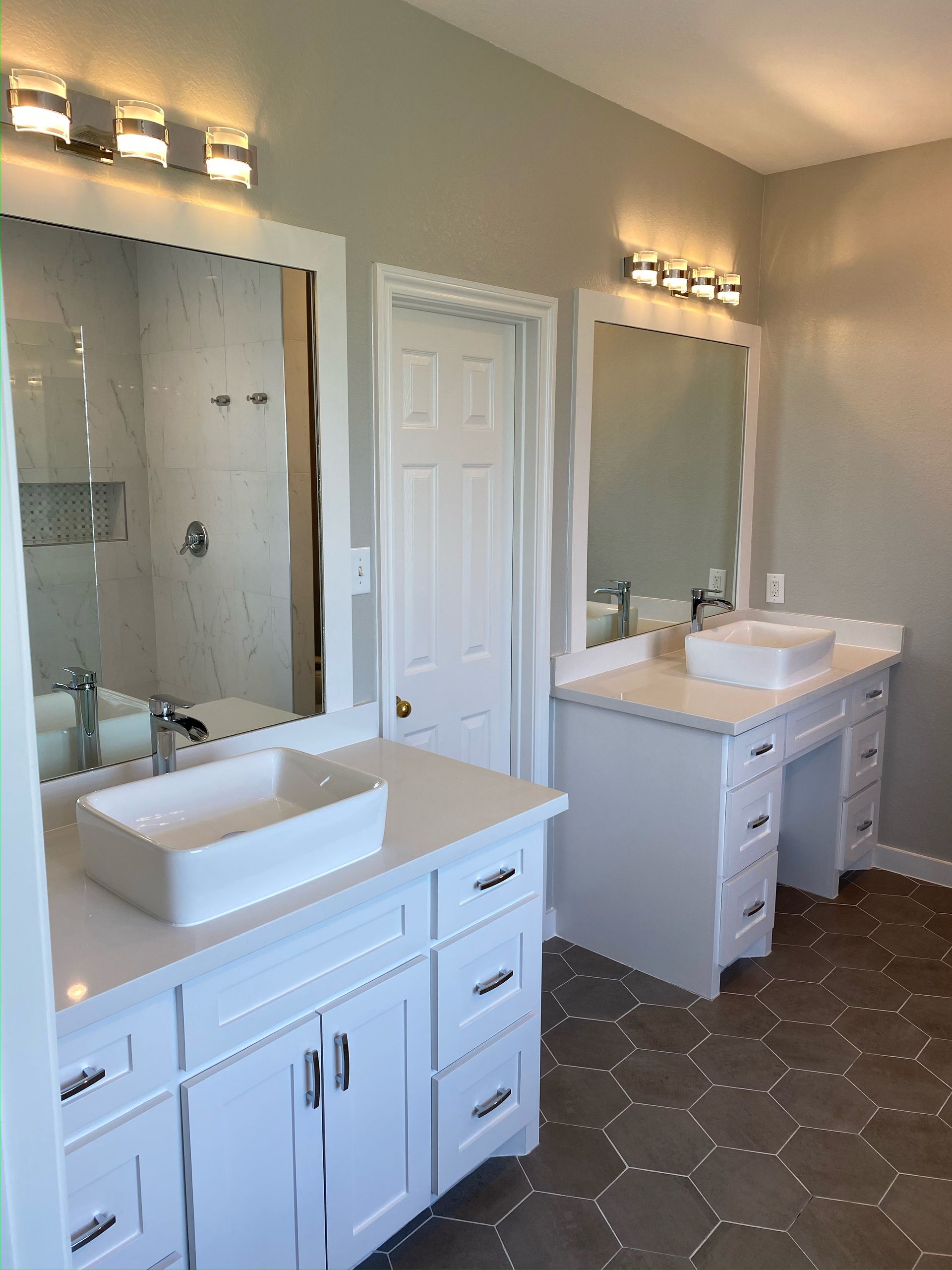 A bathroom with two sinks and two mirrors.