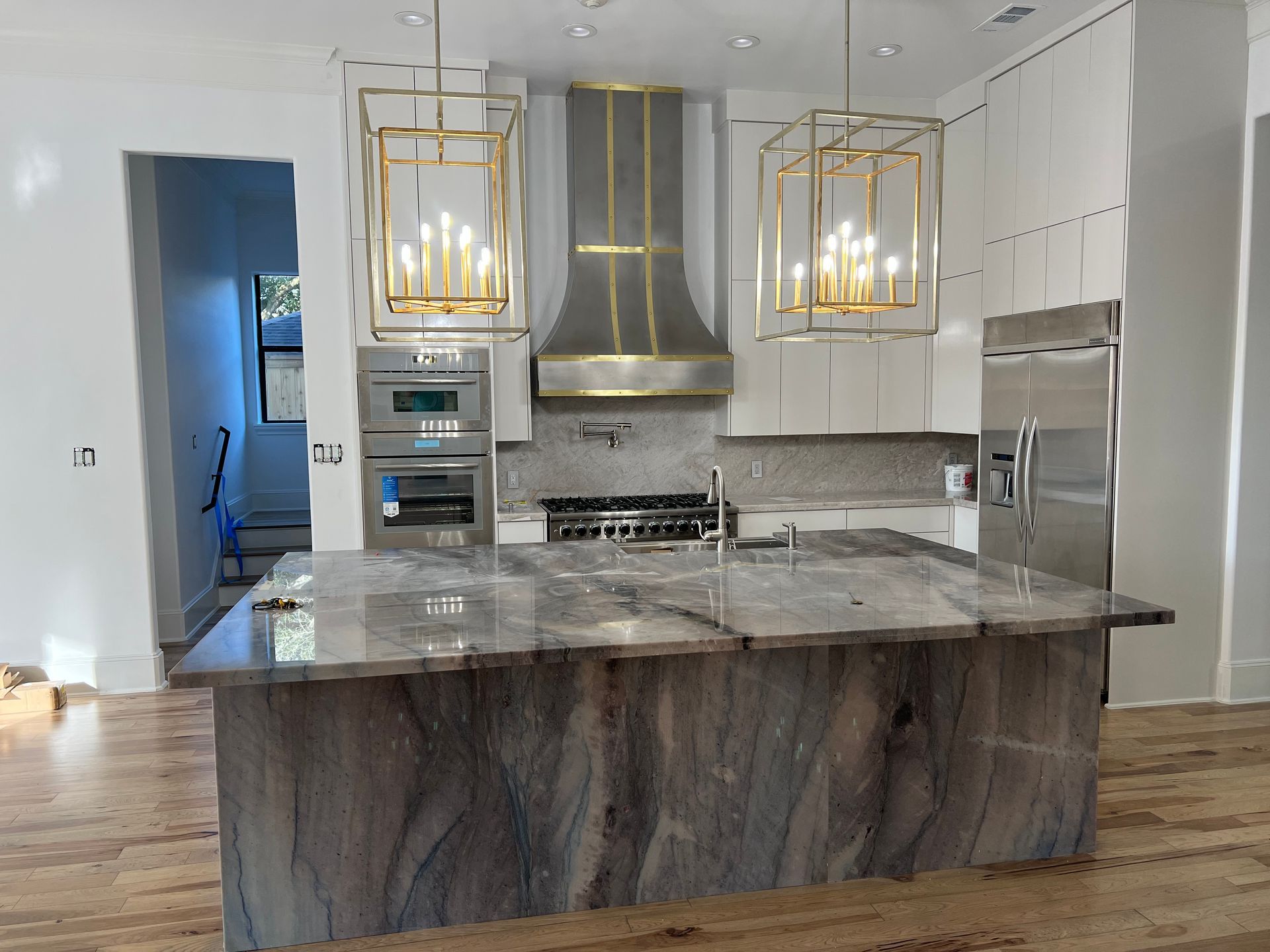 A kitchen with a large island and stainless steel appliances