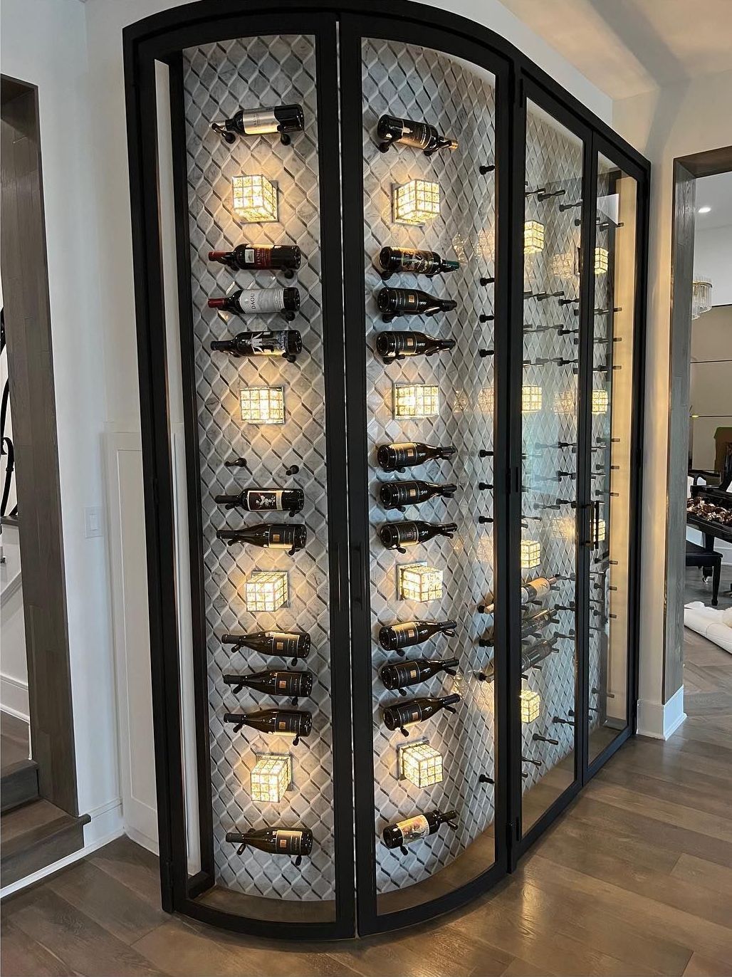 A wine cellar with a lot of wine bottles hanging on the wall.