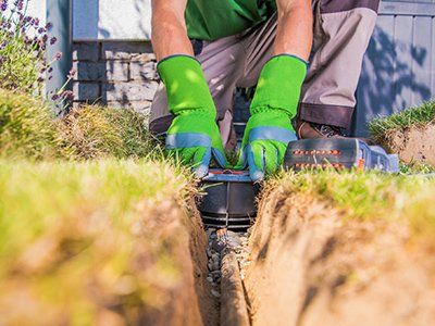 Irrigation Water Lines — Man Installing a Garden Watering System in Lewiston, ID