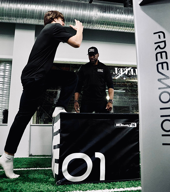 A man is jumping over a box that says free motion.