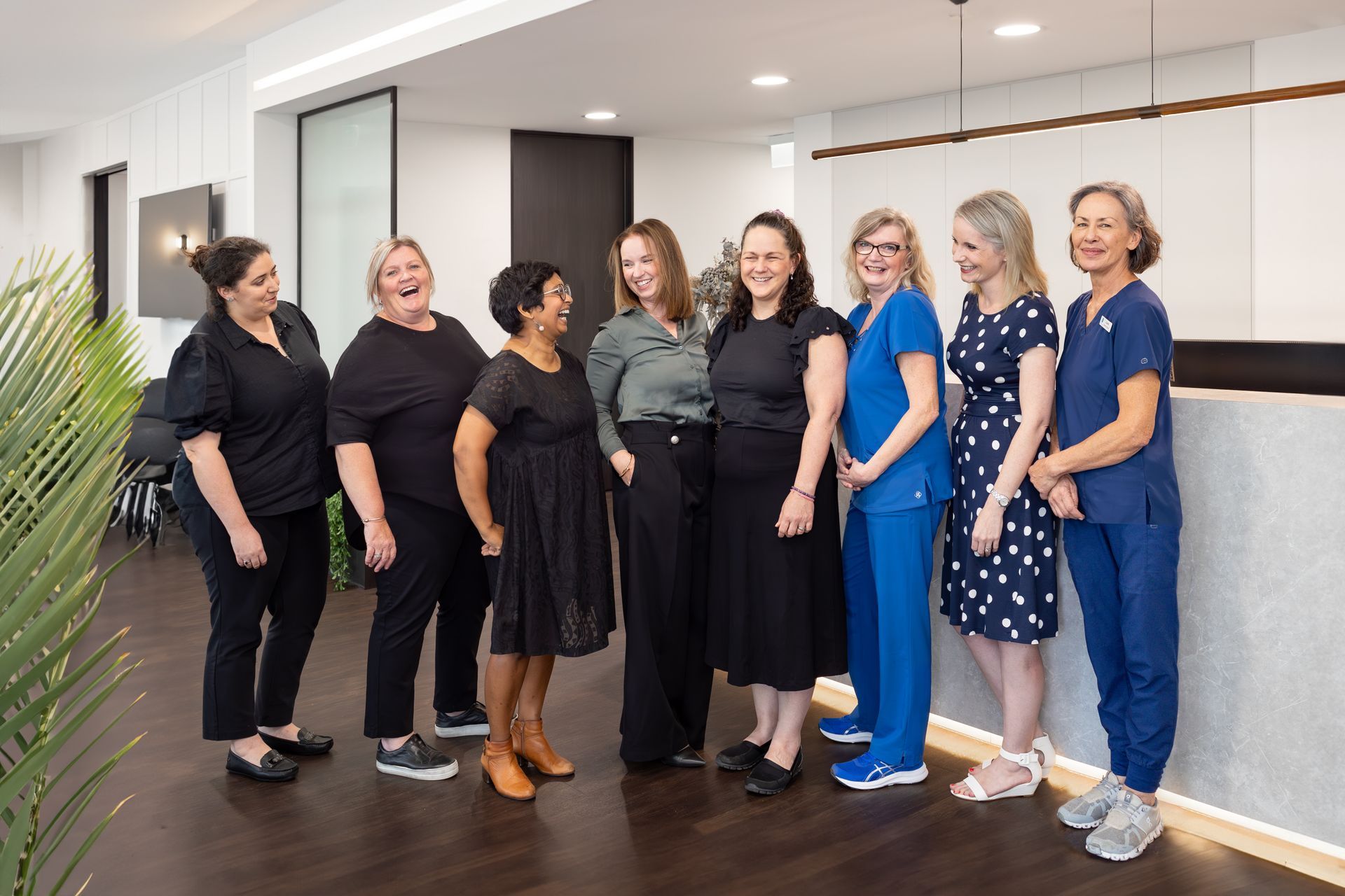 A group of doctors are sitting around a table having a meeting.