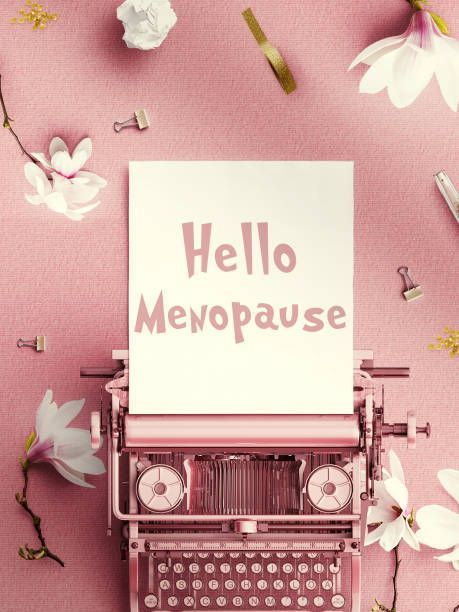 Menopause concept with typewriter text on pink background symbolizing hormonal health change. ] 