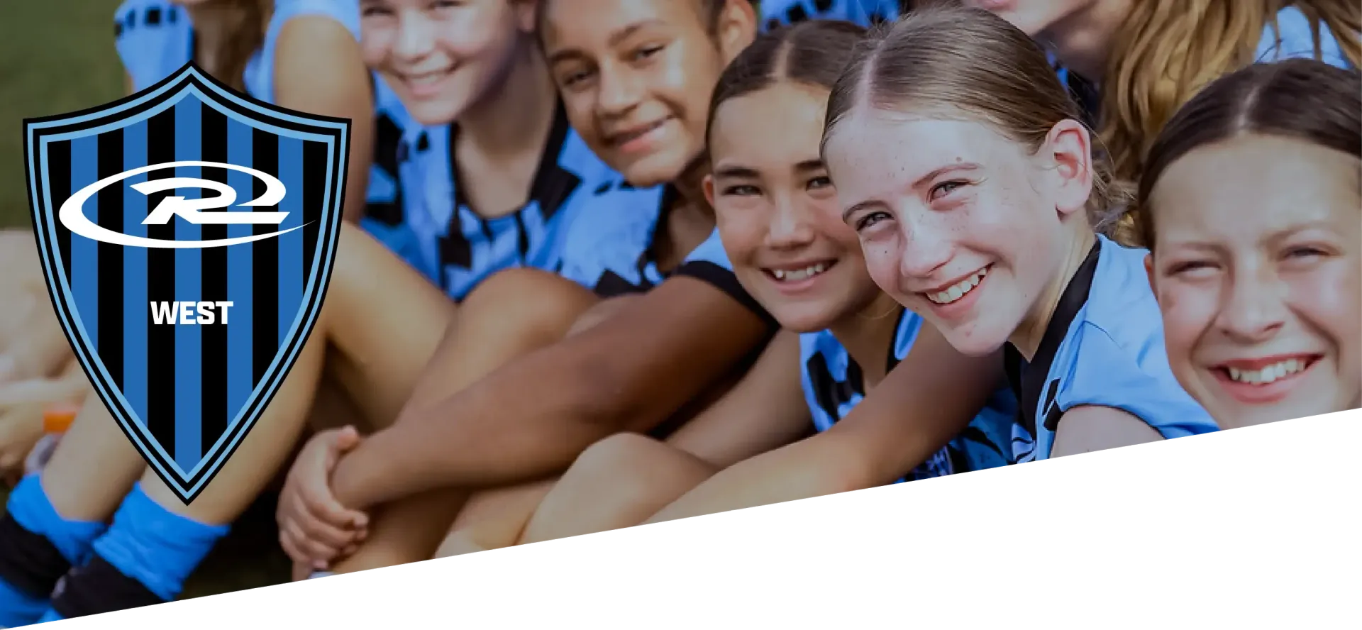 A group of smiling individuals in blue and black athletic uniforms with a