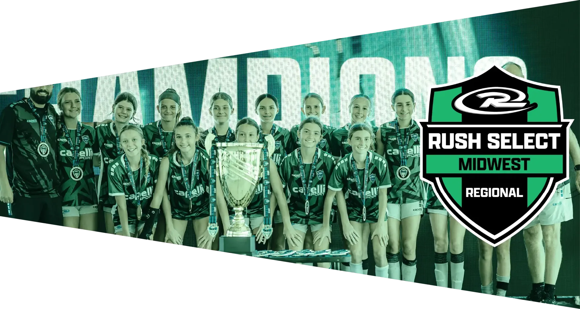 Soccer team in red and black jerseys, posed with arms around each other, with a shield logo on the right.