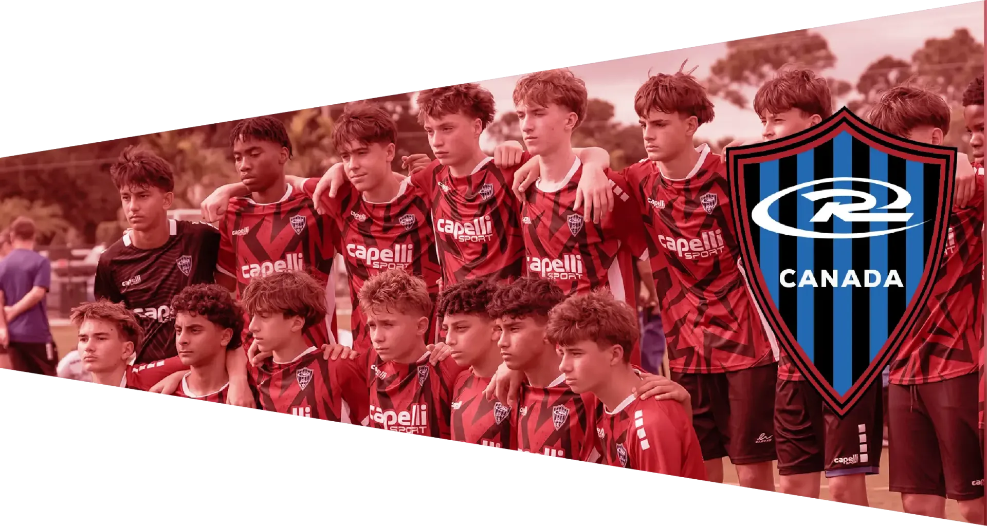 Soccer team in red and black jerseys, posed with arms around each other, with a shield logo on the right.