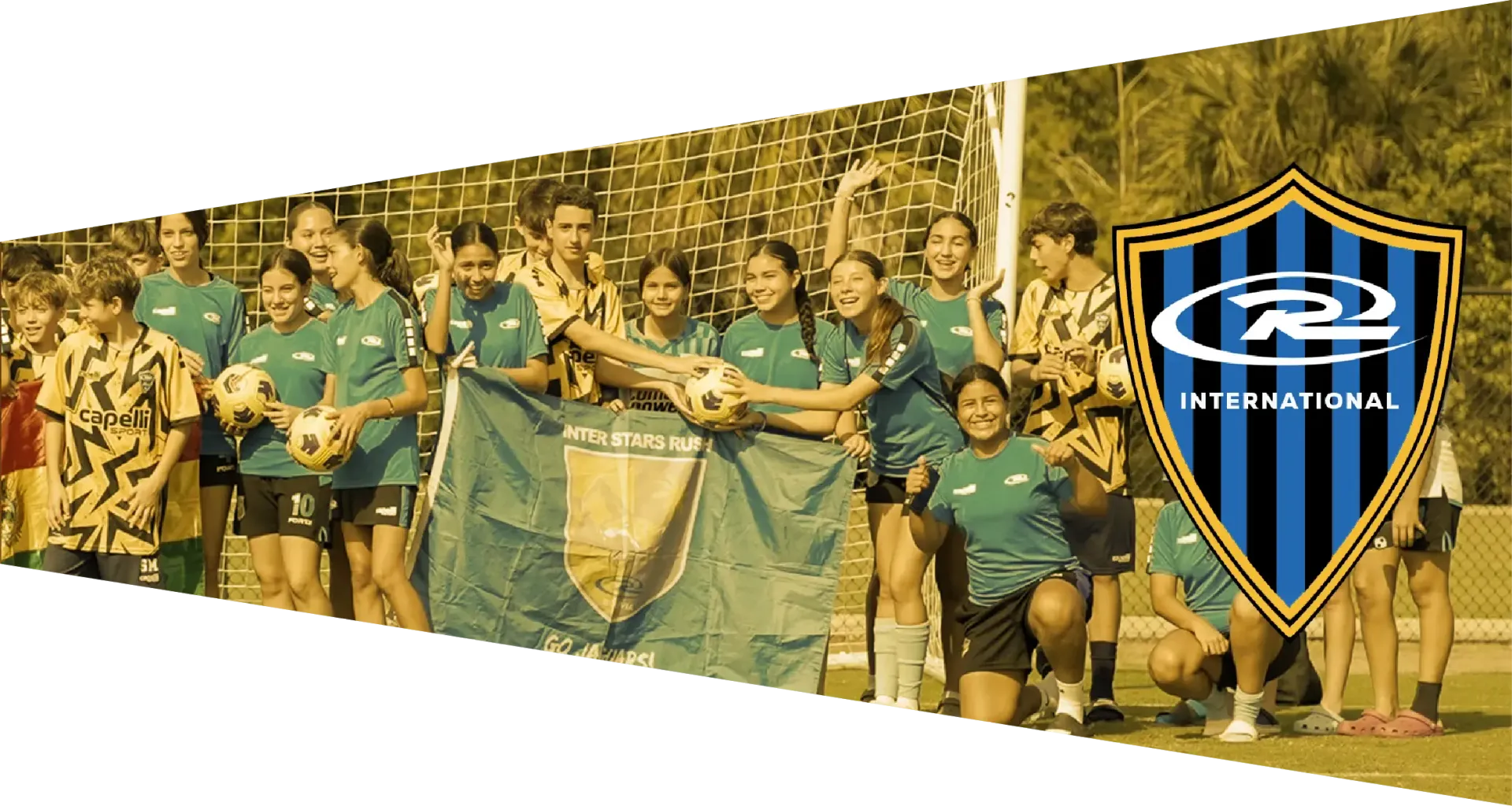Soccer team celebrates victory on a field, holding a banner; logo in the corner.
