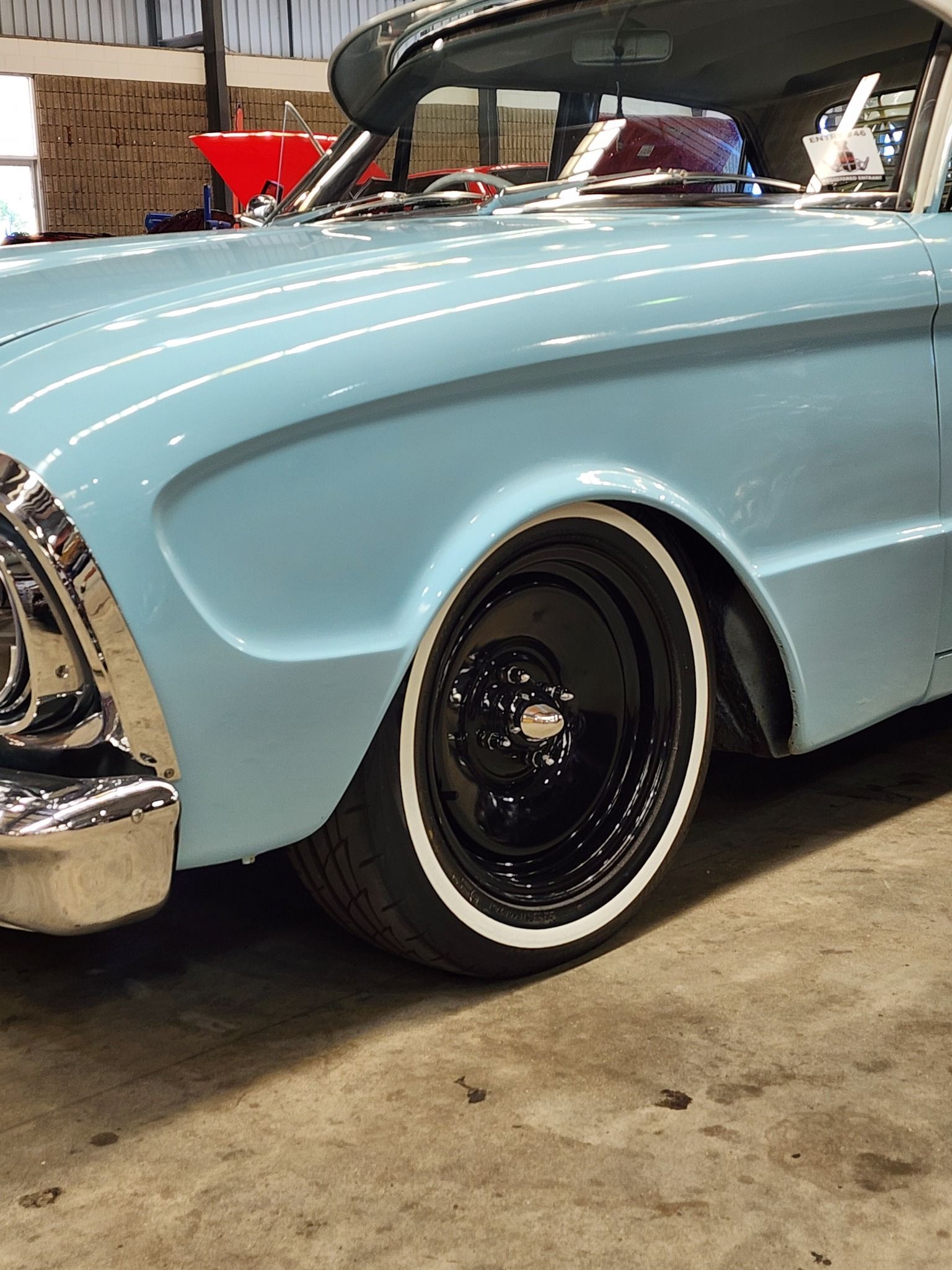 Close-up of a Light Blue Vintage Car Featuring a Glossy Black Wheel — Superior Window Tinting & Whitewalls in Portsmith, QLD