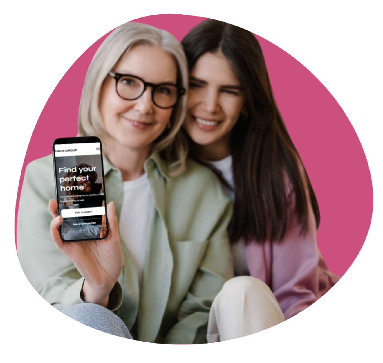 Two people smiling while one holds a smartphone displaying a website with the text 