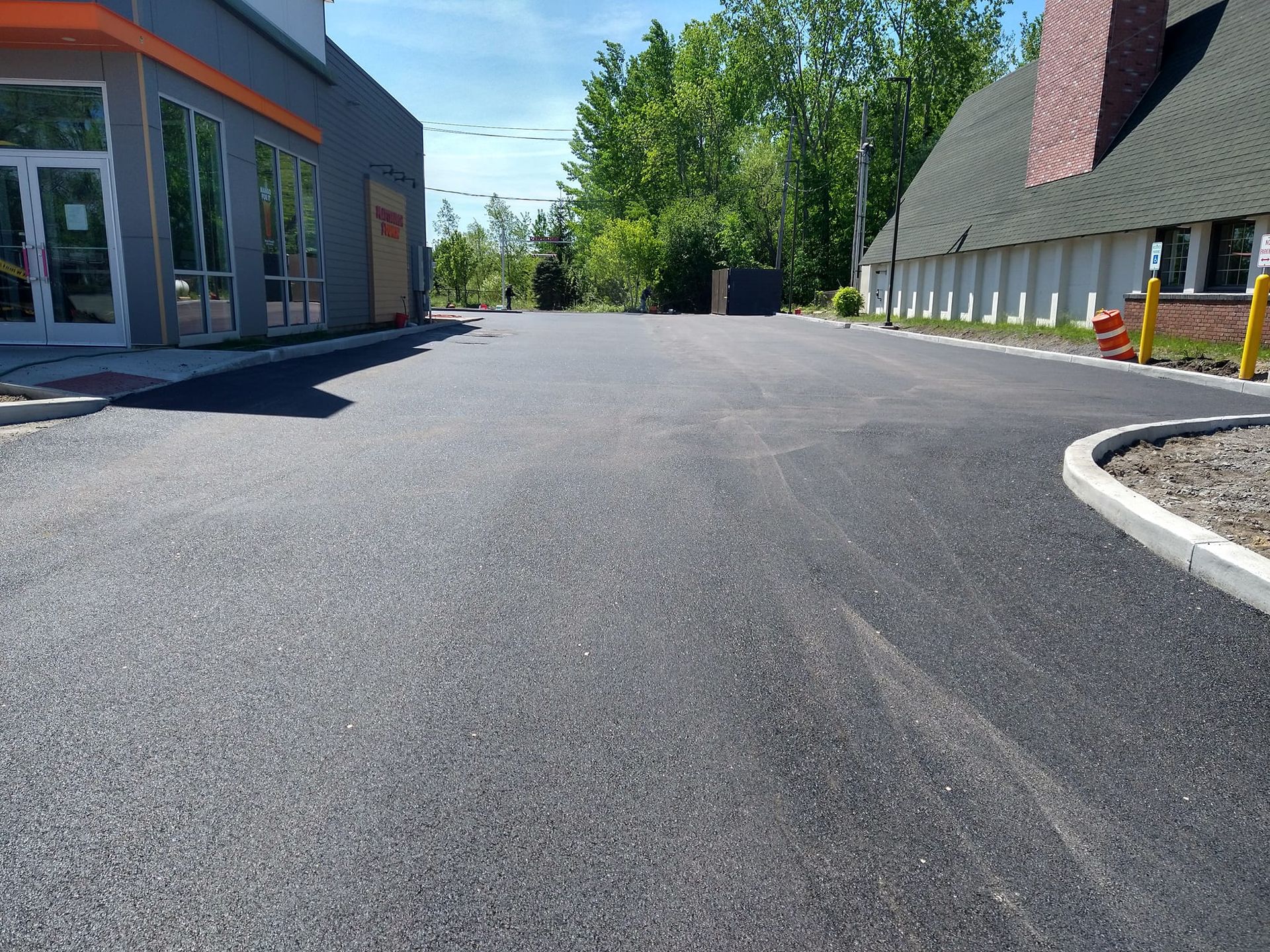 A black asphalt road with a building in the background