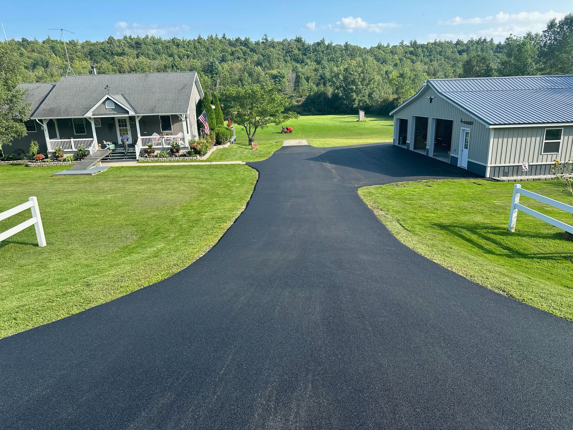 A driveway leading to a house and a garage.