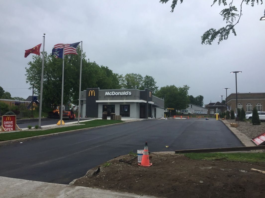 A mcdonald 's restaurant is being built on the side of the road