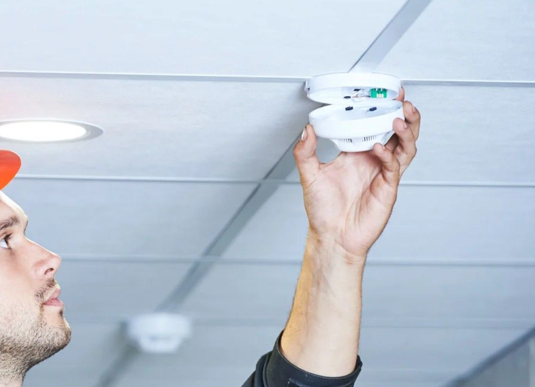 Derbyshire Electrical Specialists checking a smoke alarm at a property in Derby