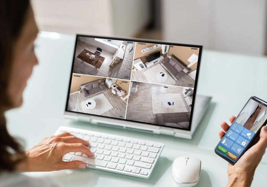 Derbyshire Electrical Specialists customer checking her home security cameras at work  in Derby