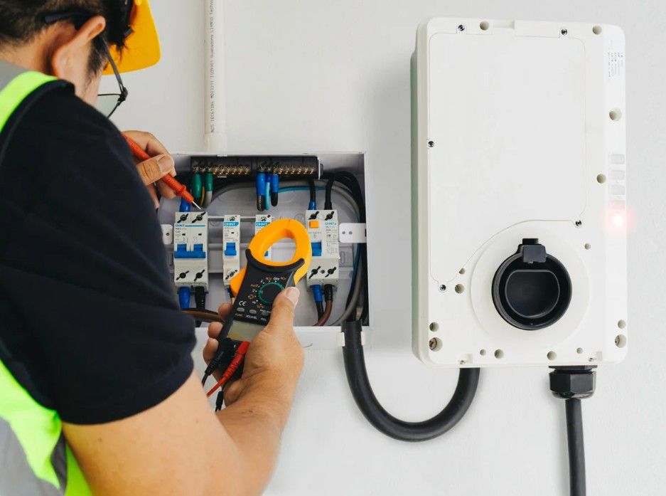 Derbyshire Electrical Specialists inspecting an 
EV charger in Derby