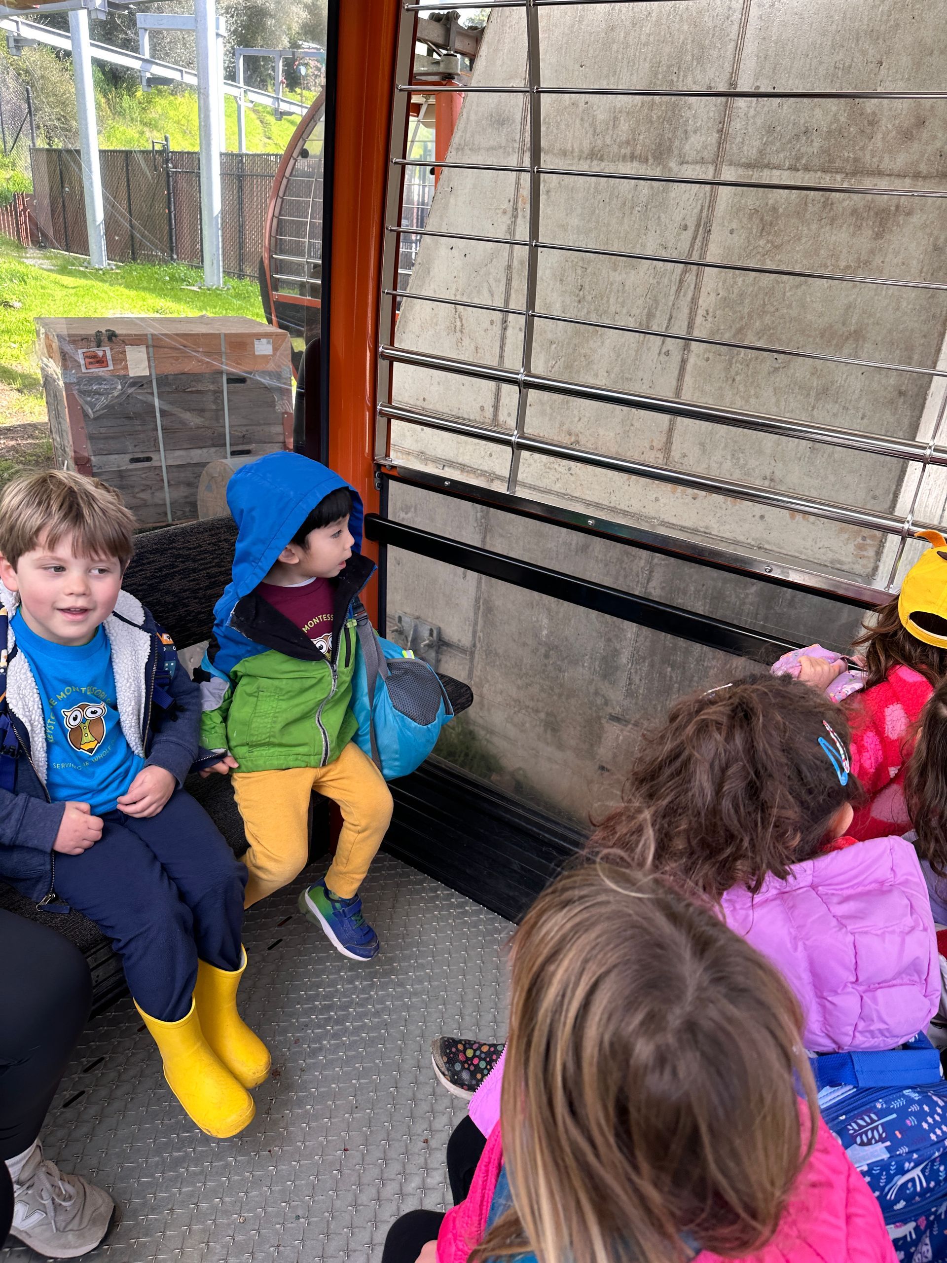 A group of Montessori child sitting in a bench the Oakland Zoo