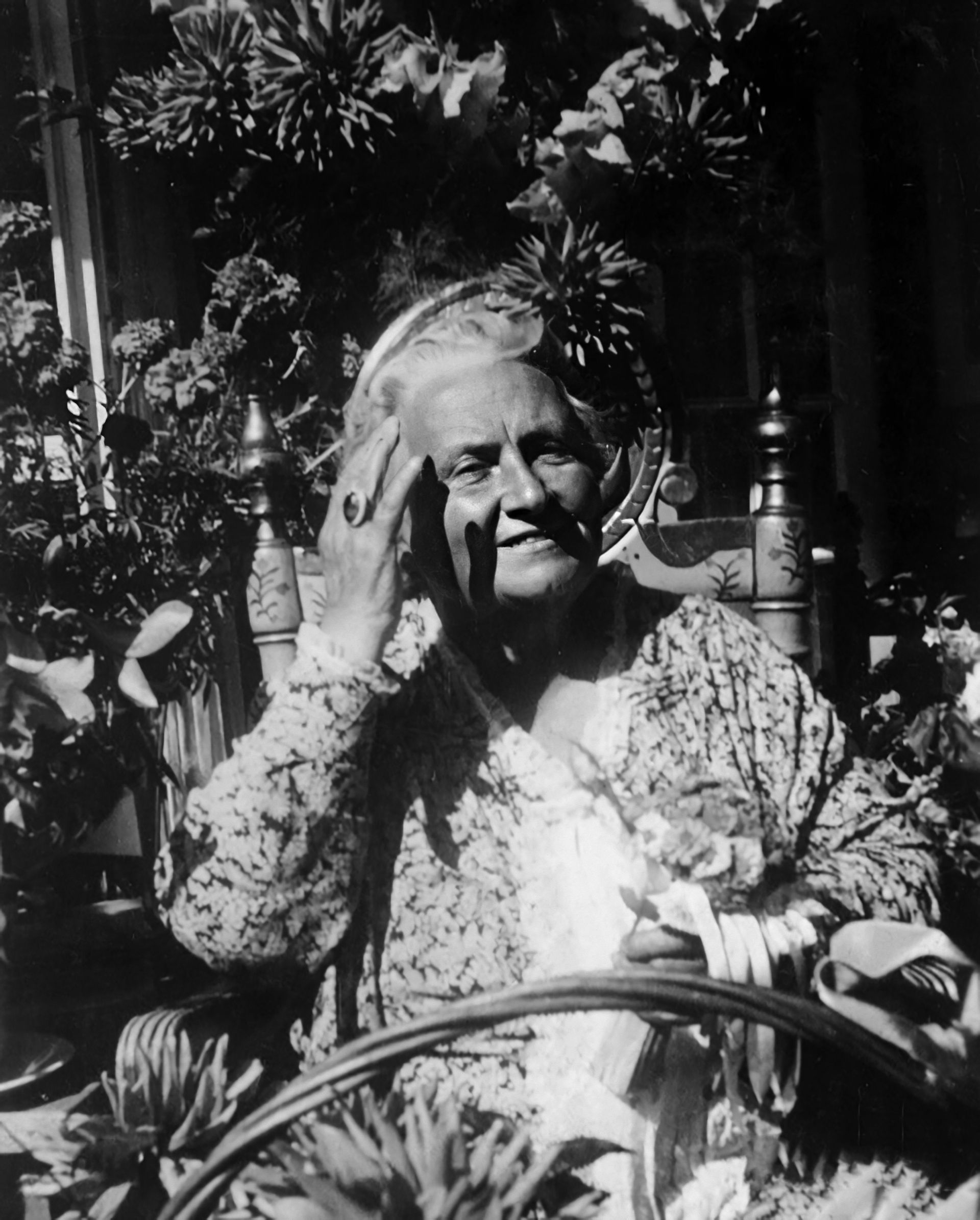 Dr. Maria Montessori seating in a garden