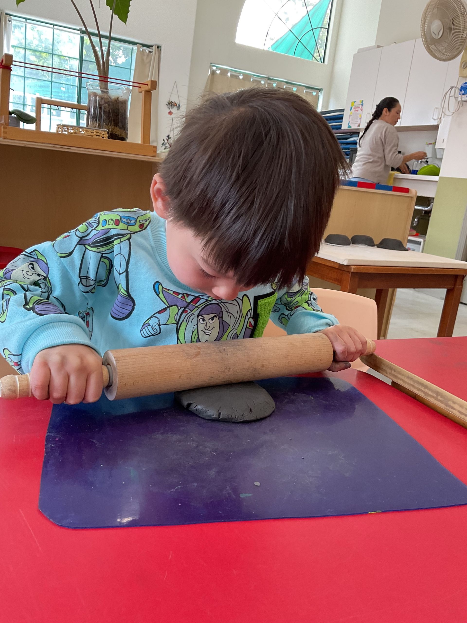 montessori child moulding a clay