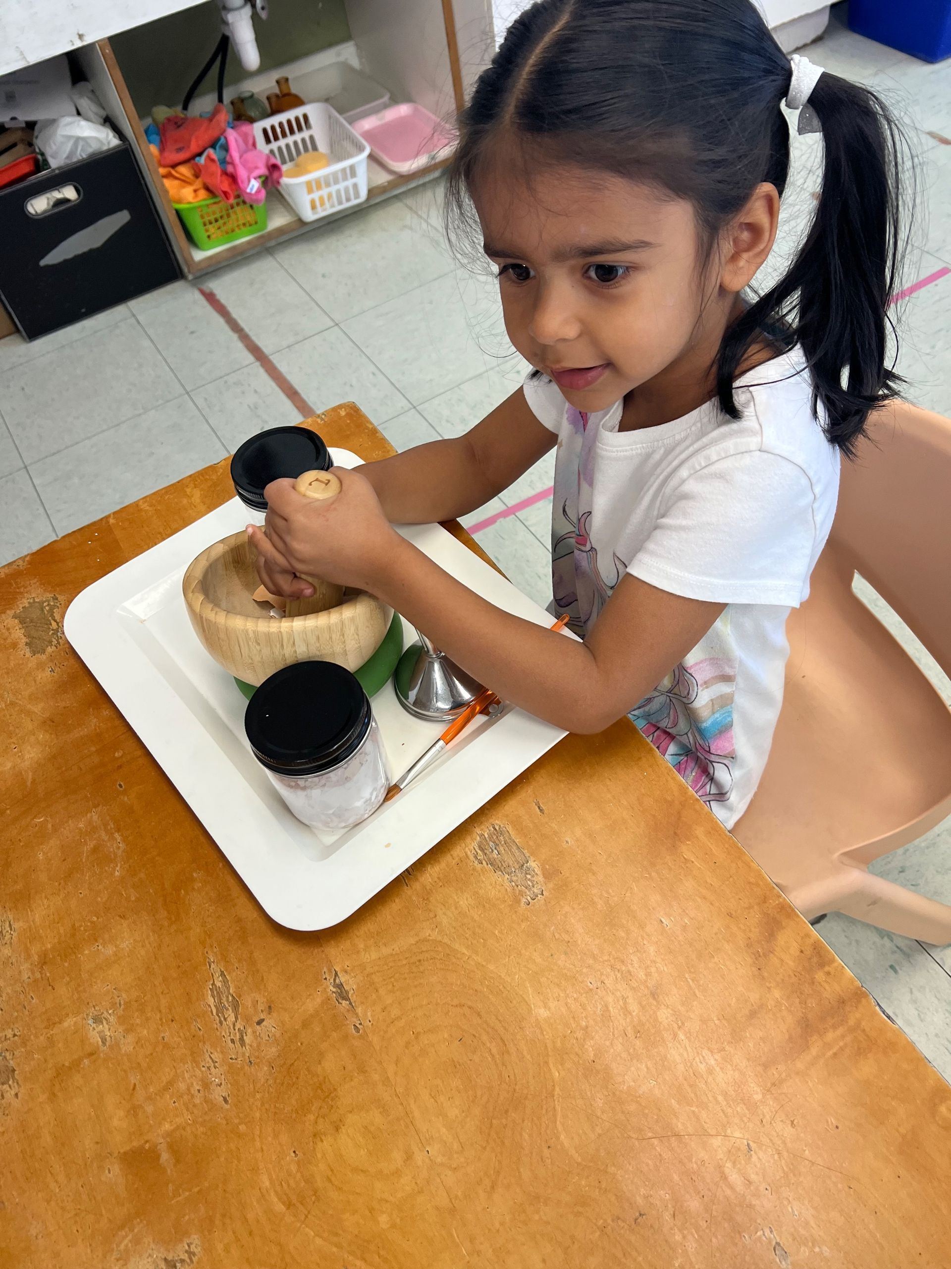 montessori child working with practical life activity