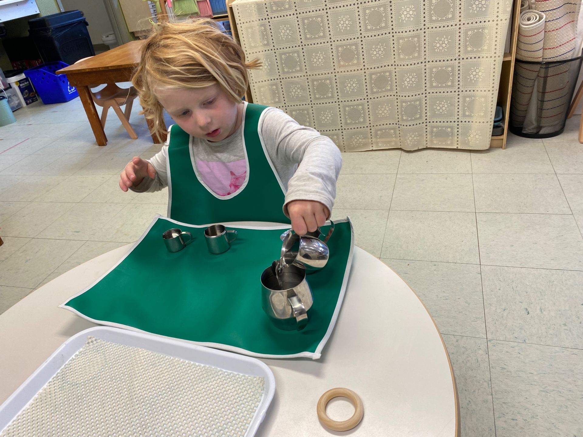 montessori child working on a practical life activity