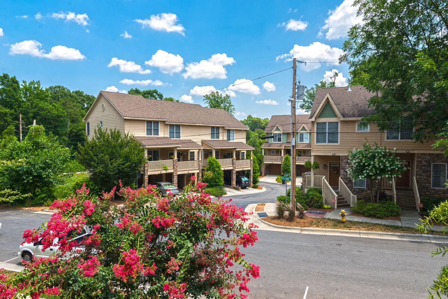 Exterior view of apartment community with landscaped flowers and trees
