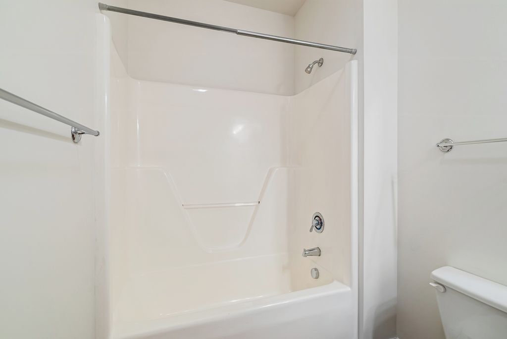 Interior view of a bathroom shower and tub area