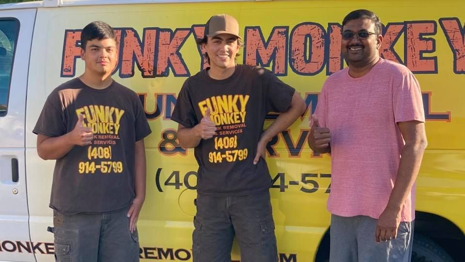 Three people in front of a van with 