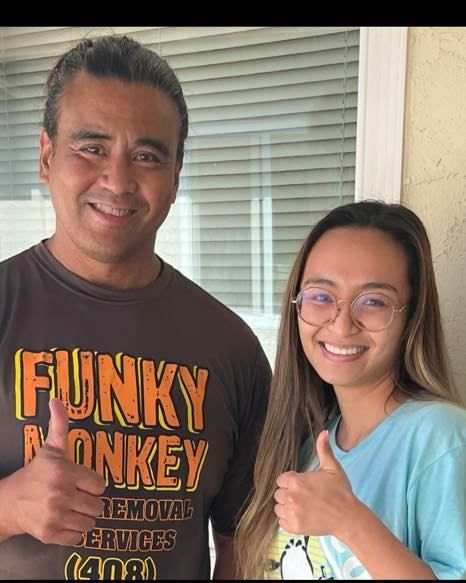 Two people with thumbs up. Man in brown 