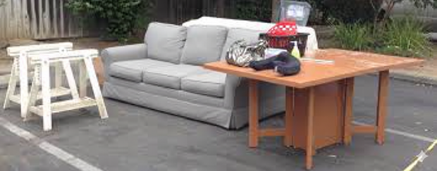 Room transformation: messy room cleared. Two men in front of clean, white-walled room, thumbs up.