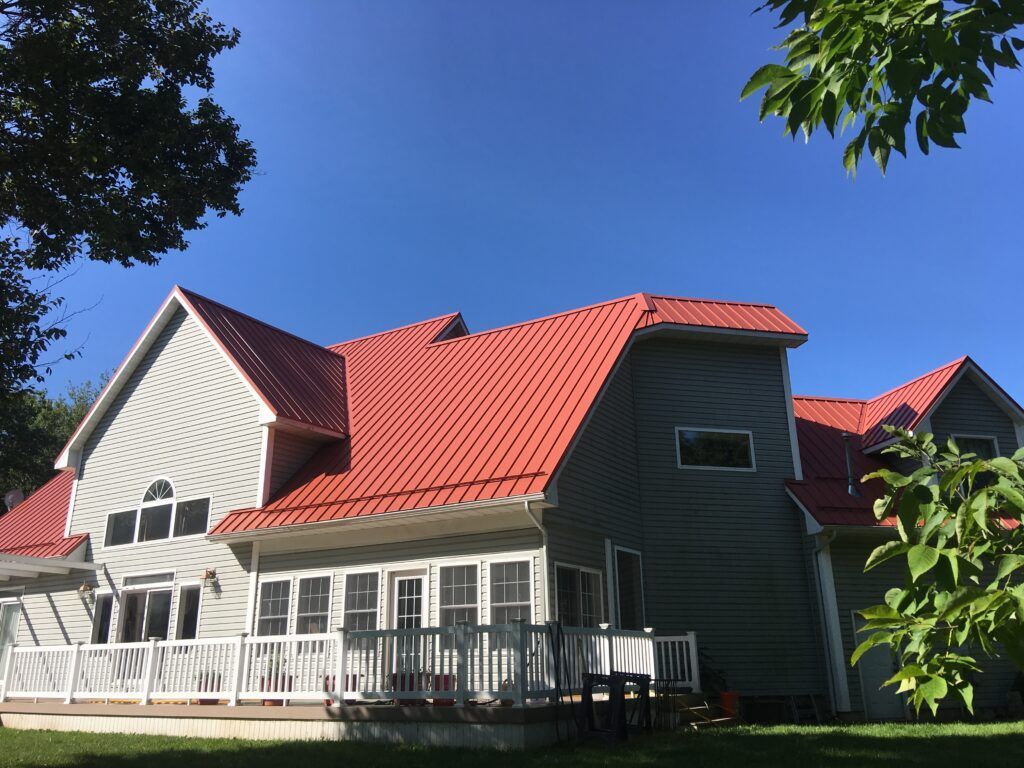 West Branch, Michigan roofing project featuring Terra Cotta standing seam metal panels, installed by experienced Northern Michigan roofers.