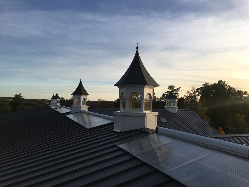 View from the roof of a Michigan horse arena, showcasing the long ridge of 24ga Musket Gray standing seam metal panels.
