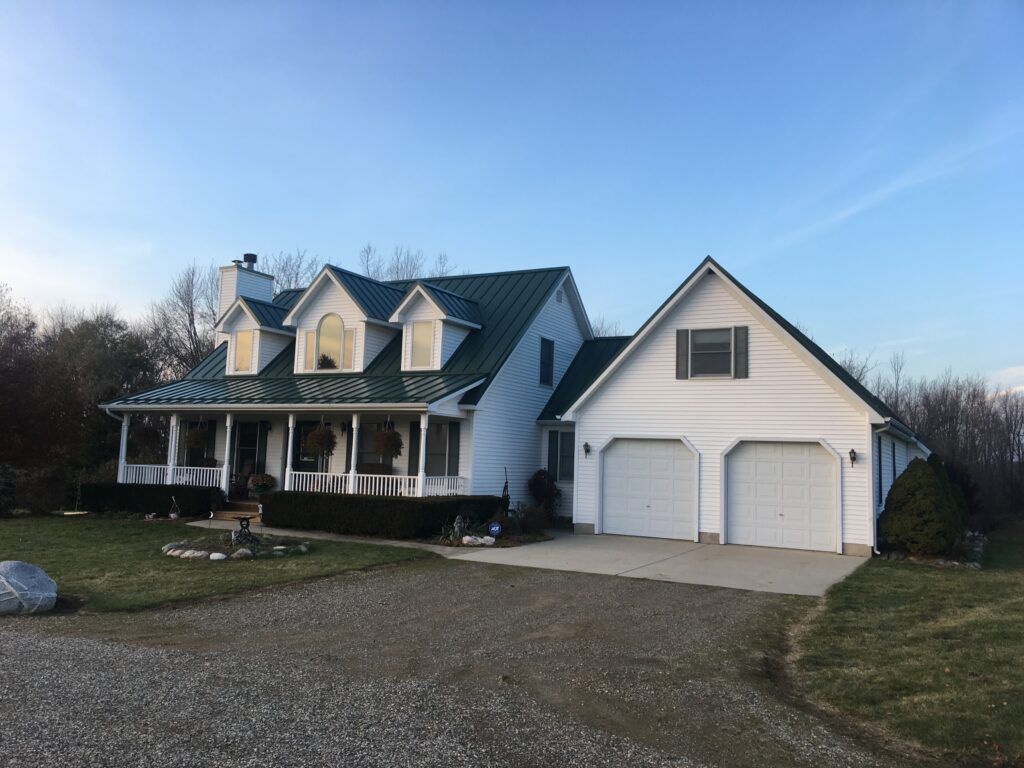 Brown City, Michigan roofing project featuring Classic Green standing seam metal panels, expertly installed by Michigan roofing professionals.
