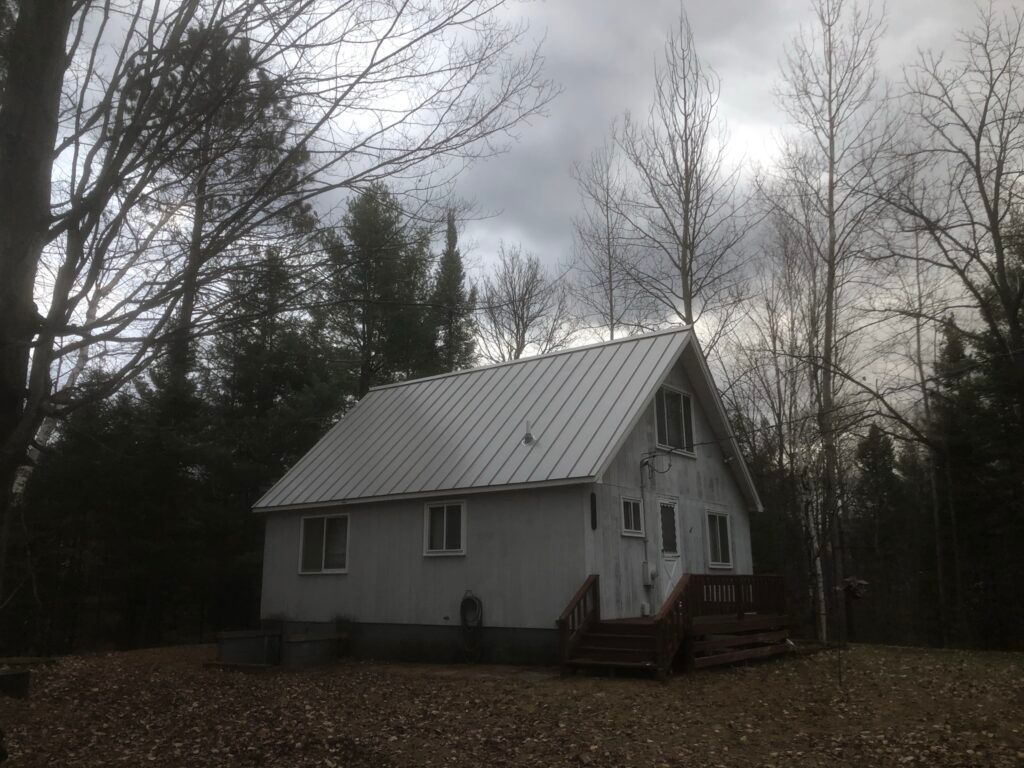 Alger, Michigan roofing project featuring Ash Grey standing seam metal panels, installed by skilled roofing professionals in Northern Michigan.