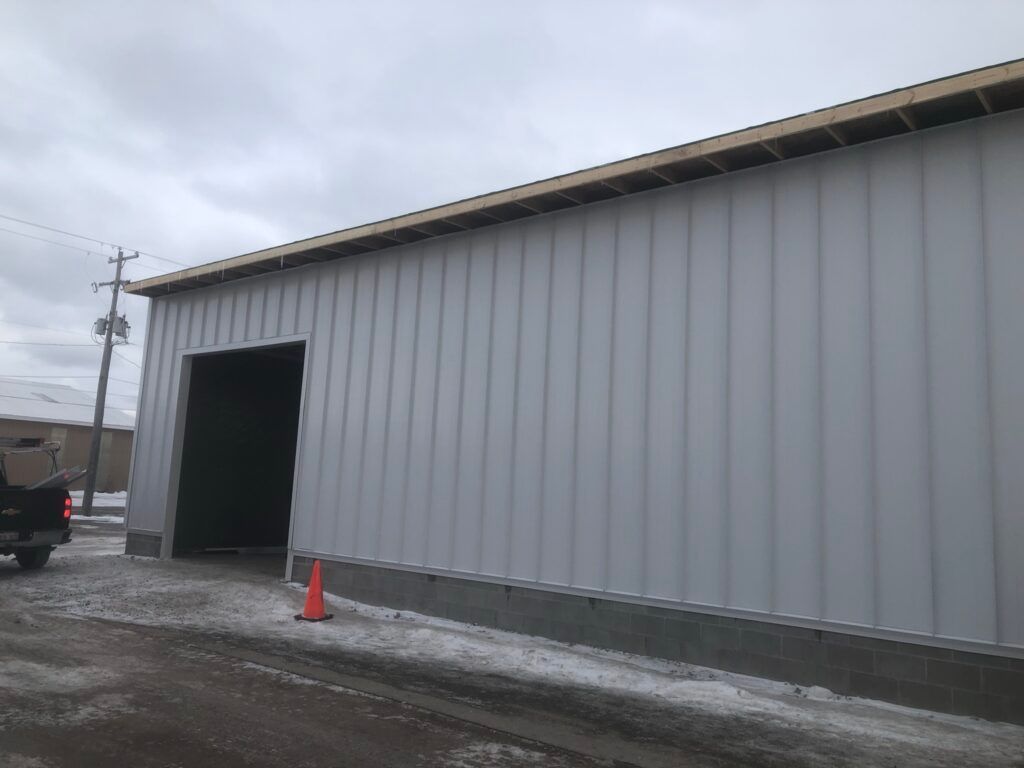 Project featuring Bright White metal siding, installed with precision by experienced Michigan siding specialists.