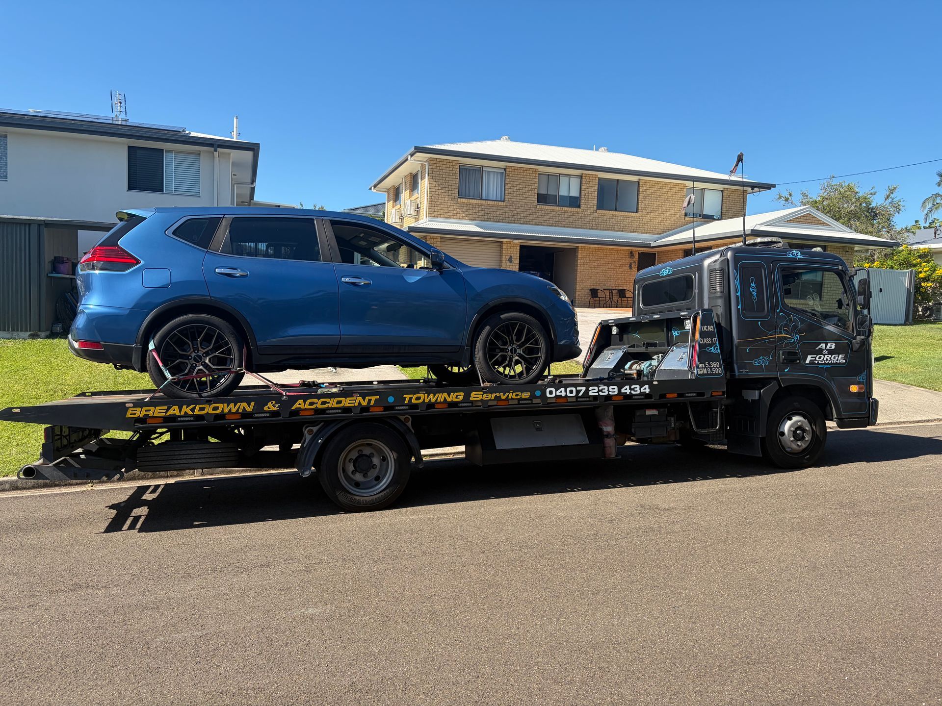 Blue SUV loaded on a flatbed tow  — A B & Forge Towing In Caboolture, QLD