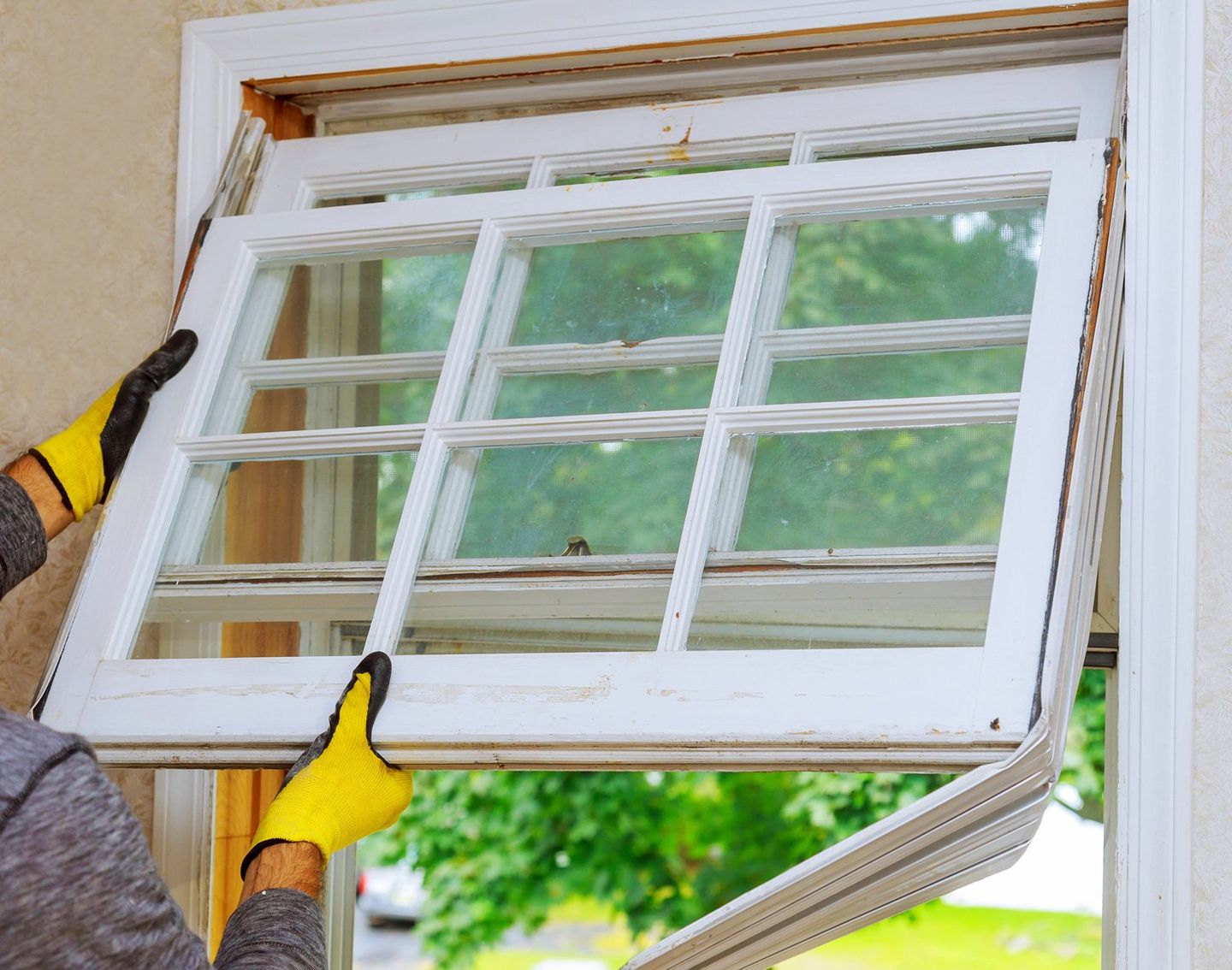 Worker Replacing Window — Oak Ridge, TN — Hatchers Seamless Guttering