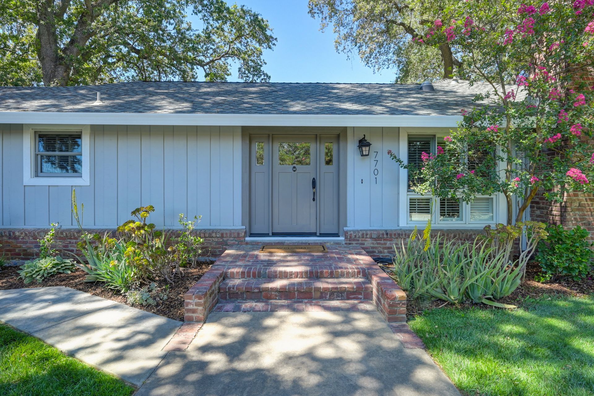 A house with a brick walkway leading to the front door. Find Homes for sale in East Sac with Rich Cazneaux Real Estate Group