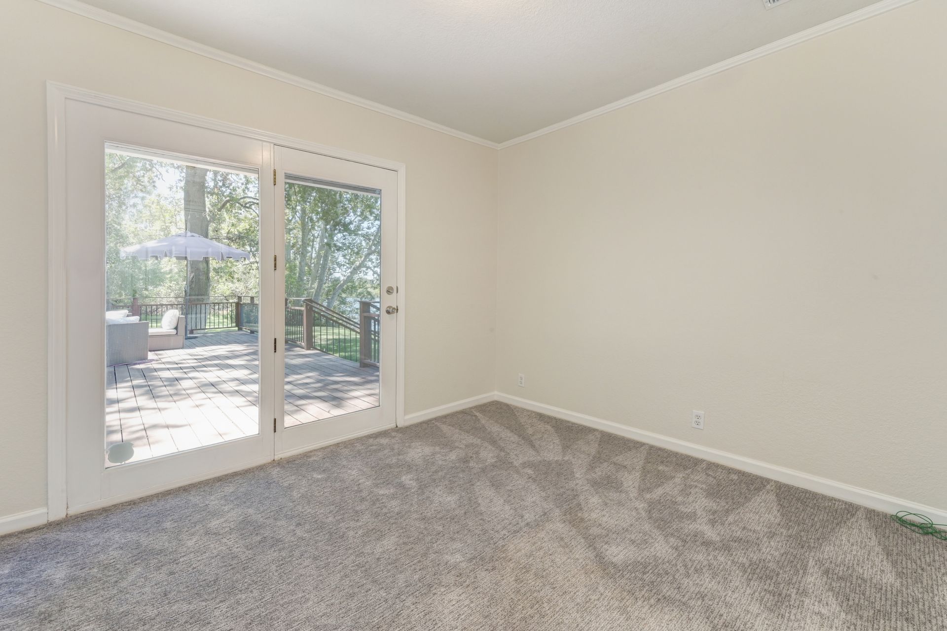 An empty room with a sliding glass door. Find the Top Real Estate Agents in East Sac with Rich Cazneaux Real Estate Group