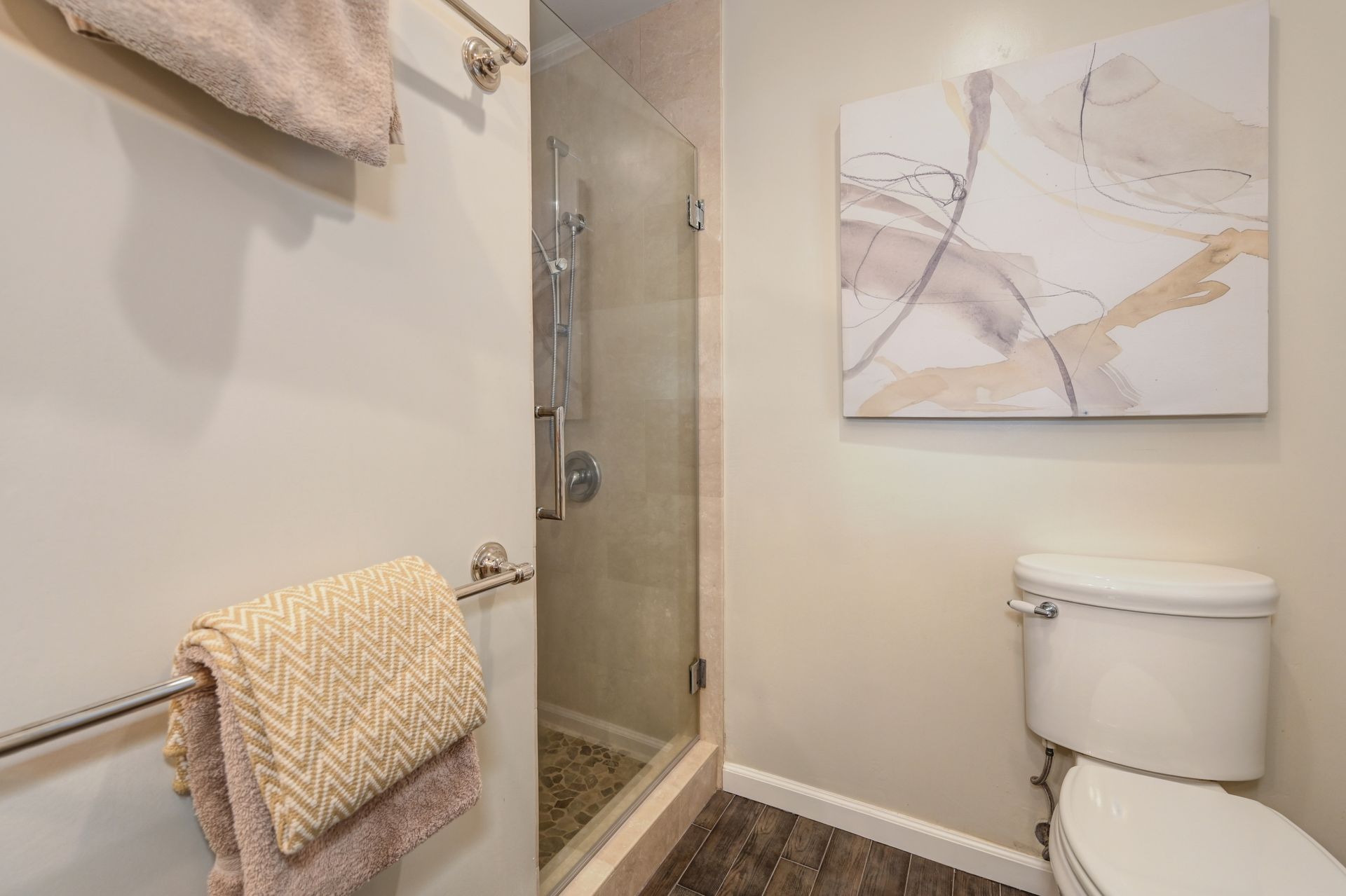 Clean bathroom with a toilet and shower area. Rich Cazneaux: The Best Listing Agent in East Sac for Finding Your Ideal Home
