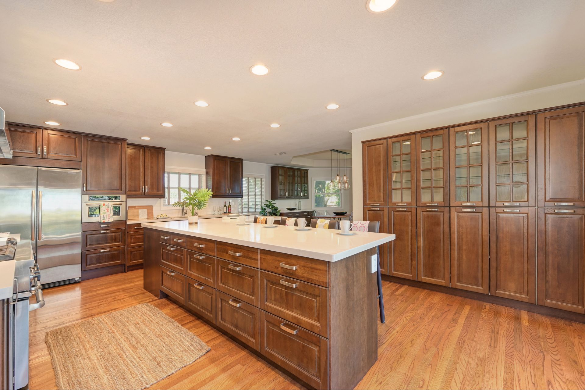 A kitchen with wooden furniture & a center island. Find Top Listing Agents in East Sac, with Rich Cazneaux Real Estate Group