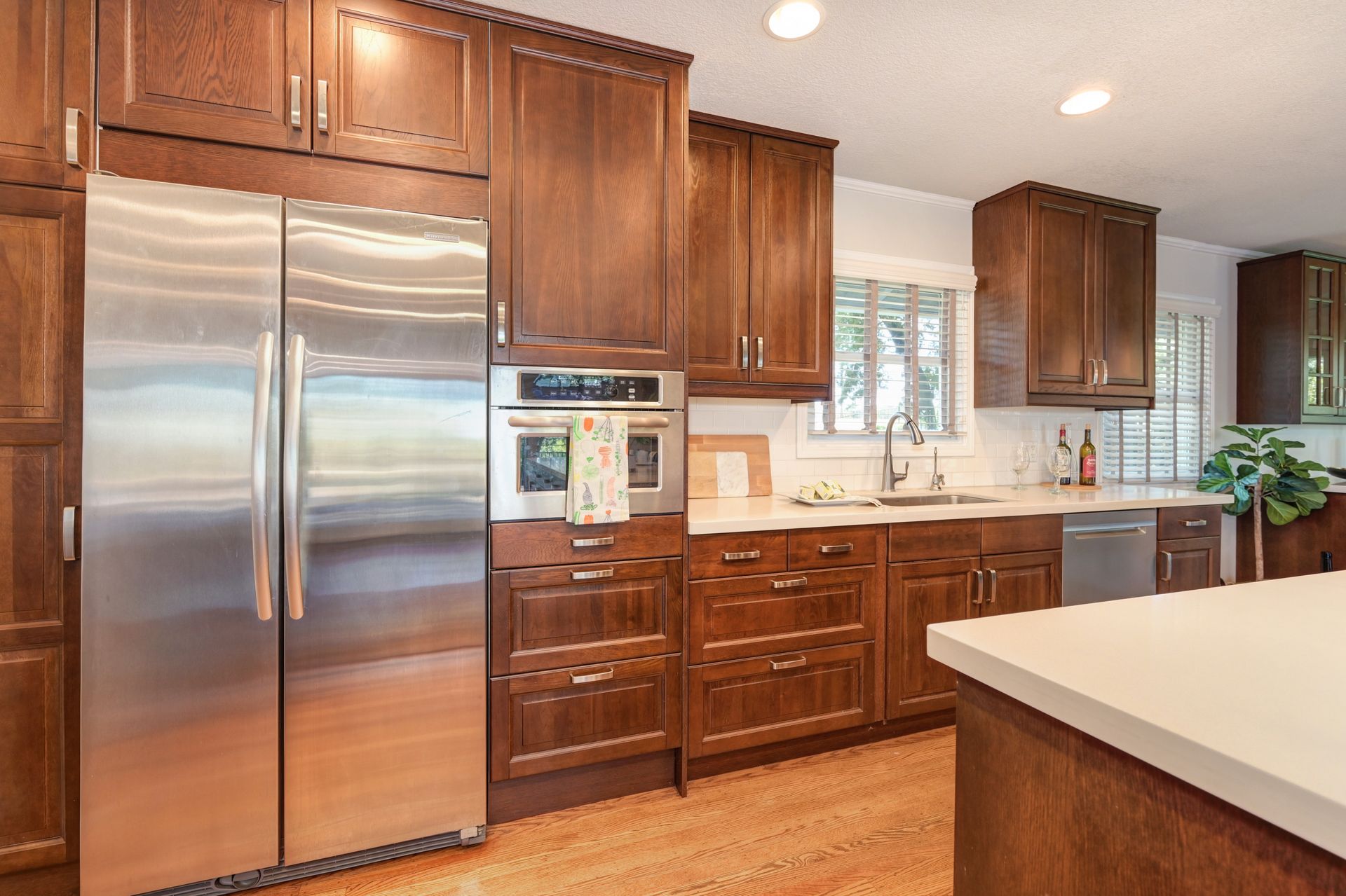 A kitchen with stainless steel appliances and wooden cabinets. Buy a House in East Sac, with Rich Cazneaux Real Estate Group